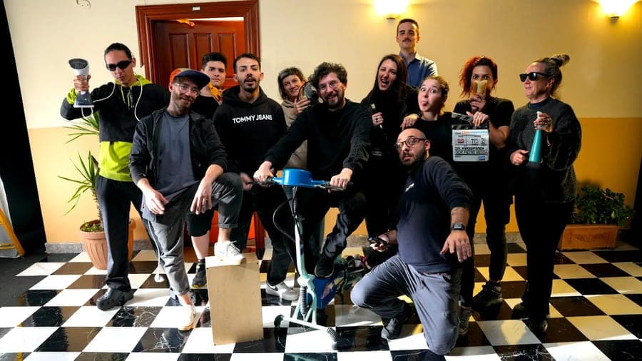 The team posing on a checkerboard floor